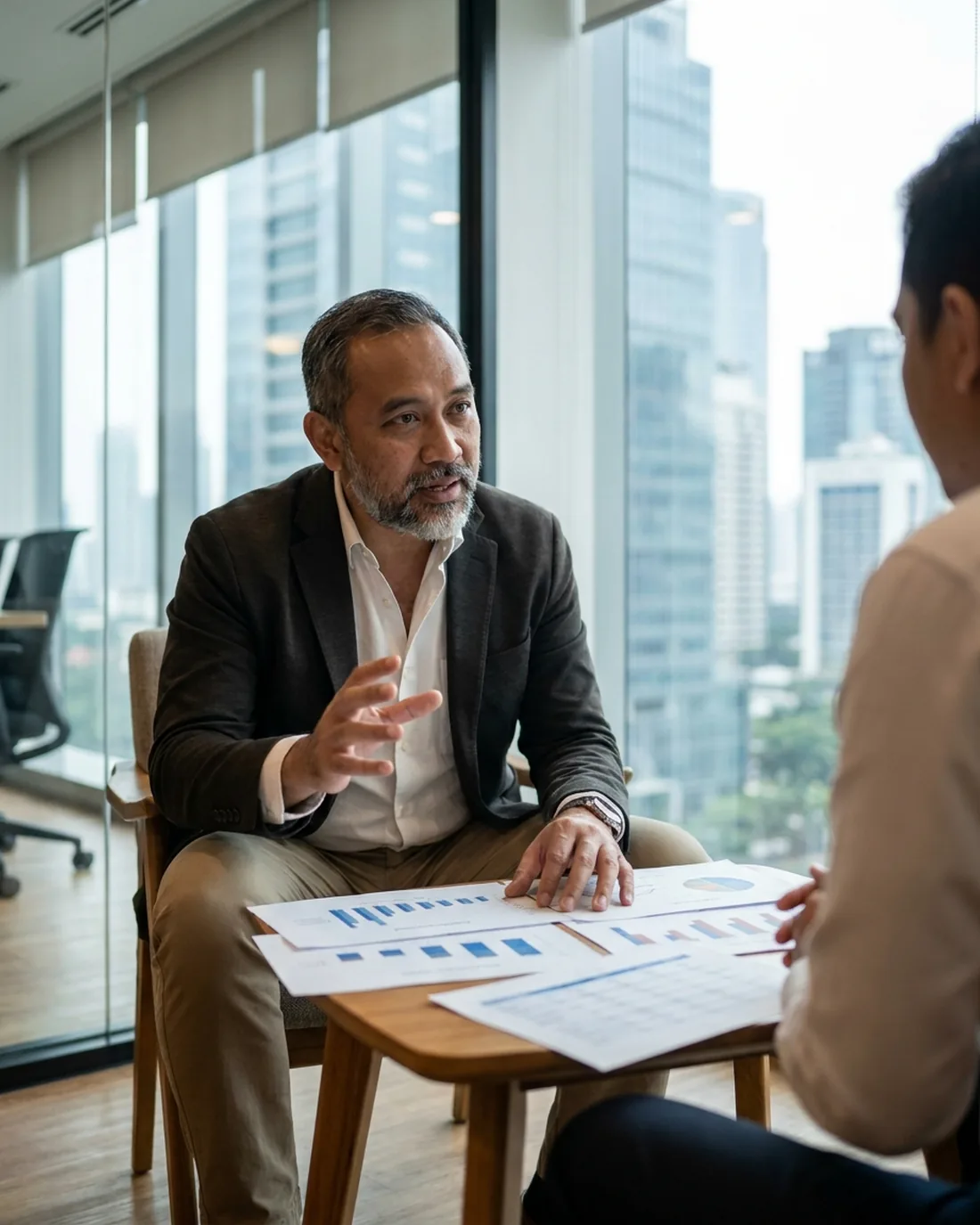 A senior CRO reviewing the work in a calm Jakarta boardroom